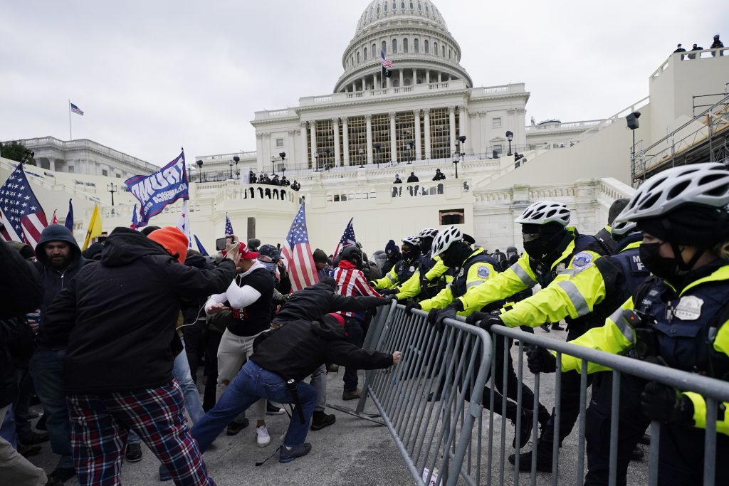 FILE - In this Jan. 6, 2021 file photo, Trump supporters try to break through a police barrier at the Capitol in Washington. A House committee tasked with investigating the Jan. 6 Capitol insurrection is moving swiftly to hold at least one of Donald Trump’s allies, former White House aide Steve Bannon, in contempt. That's happening as the former president is pushing back on the probe in a new lawsuit. (AP Photo/Julio Cortez)