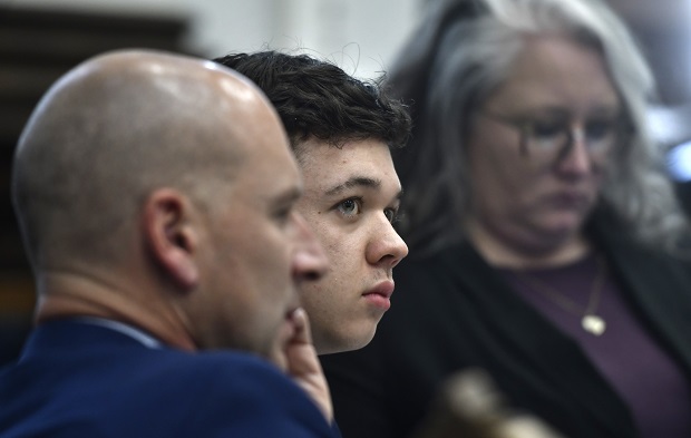 Kyle Rittenhouse, center, looks up and away from a video monitor as footage of him shooting on the night of Aug. 25, 2020, is shown during the trial at the Kenosha County Courthouse in Kenosha on Wednesday. (Sean Krajacic/The Kenosha News via AP, Pool)