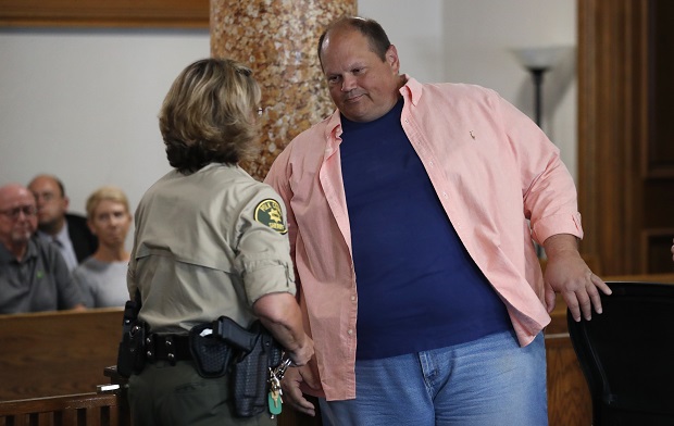 Eddie Tipton, a former lottery computer programmer, right, is taken into custody following a sentencing hearing on Aug. 22, 2017, at the Polk County Courthouse in Des Moines, Iowa. Tipton, serving a 25-year prison sentence for conspiracy to commit theft by rigging computers to win jackpots for himself and his friends and family, is suing the state of Iowa, claiming he was placed under duress four years ago to plead guilty to crimes he had not committed. (AP Photo/Charlie Neibergall File)