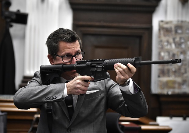 Assistant District Attorney Thomas Binger holds Kyle Rittenhouse's gun as he gives the state's closing argument in Kyle Rittenhouse's trial at the Kenosha County Courthouse in Kenosha on Monday.  Rittenhouse is accused of killing two people and wounding a third during a protest over police brutality in Kenosha, last year.  (Sean Krajacic/The Kenosha News via AP, Pool)