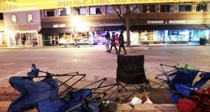Toppled chairs line West Main Street in downtown Waukesha after an SUV drove into a parade of Christmas marchers on Sunday. (John Hart/Wisconsin State Journal via AP)