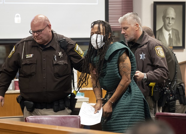 Darrell Brooks, center, is escorted out of the courtroom after making his initial appearance on Tuesday in Waukesha County Court in Waukesha. Prosecutors in Wisconsin have charged Brooks with intentional homicide in the deaths of at least five people who were killed when an SUV was driven into a Christmas parade. (Mark Hoffman/Milwaukee Journal-Sentinel via AP, Pool)