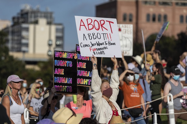A crowd gathers for the Women's March ATX rally on Oct., 2, 2021, at the Texas State Capitol in Austin, Texas.  An expected decision by the U.S. Supreme Court in the coming year to severely restrict abortion rights or overturn Roe v. Wade entirely is setting off a renewed round of abortion battles in state legislatures. (AP Photo/Stephen Spillman, File)