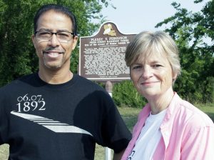 FILE - Keith Plessy and Phoebe Ferguson, descendants of the principals in the Plessy V. Ferguson court case, stand in front of a historical marker in New Orleans, on June 7, 2011.  Homer Plessy, the namesake of the U.S. Supreme Court’s 1896 “separate but equal” ruling, is being considered for a posthumous pardon. The Creole man of color died with a conviction still on his record for refusing to leave a whites-only train car in New Orleans in 1892.  (AP Photo/Bill Haber, File)