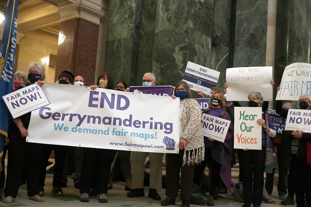 More than 100 opponents of the Republican redistricting plans vow to fight the maps at a rally ahead of a joint legislative committee hearing at the Wisconsin state Capitol on Oct. 28,. The Wisconsin Supreme Court is scheduled to hear arguments in a redistricting case that could determine political boundary lines in the battleground state for the next decade. (AP Photo/Scott Bauer, File)