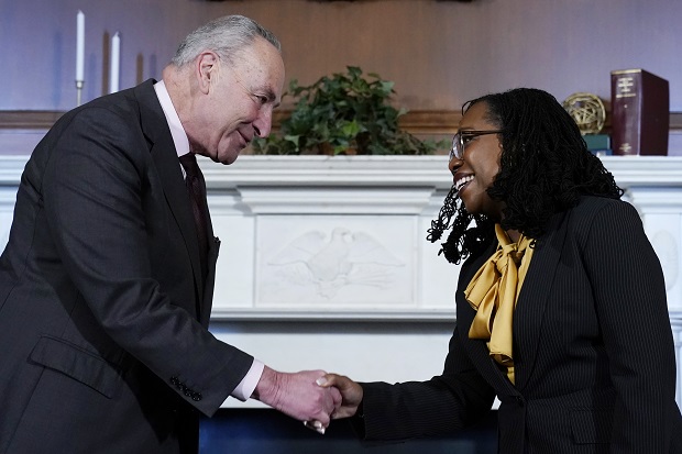 Senate Majority Leader Chuck Schumer of New York, left, shakes hands with Supreme Court nominee Ketanji Brown Jackson, right, at the beginning of their meeting on Capitol Hill in Washington on Wednesday. (AP Photo/Susan Walsh)