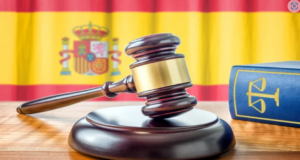 Image of a judge's gavel with flag of Spain. Credit: Sutterstock
